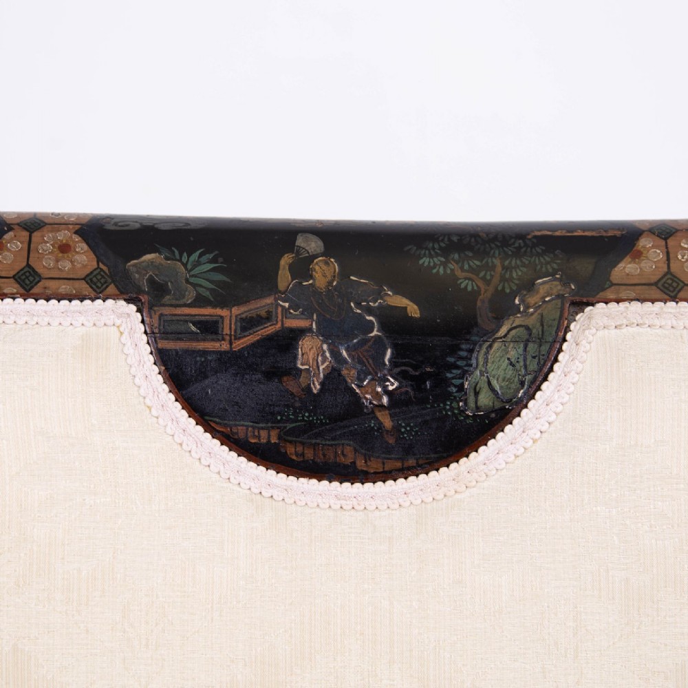 A Victorian Chinoiserie sofa with a black lacquered frame featuring gilt painted details, semicircular cream patterned back panels, and cream upholstered seat cushions. View XIII
