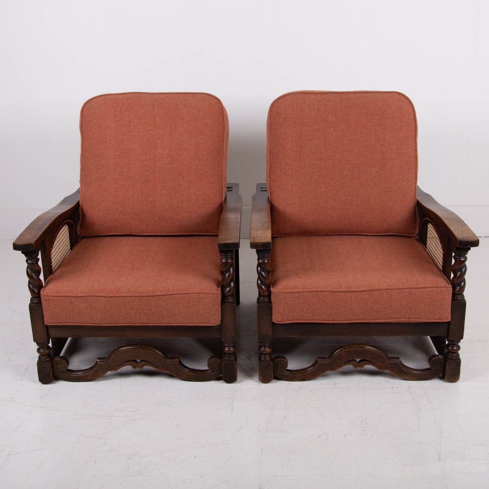 A pair of 1920s dark oak armchairs featuring barley twist supports, woven cane side panels, and terracotta upholstered cushions. View III
