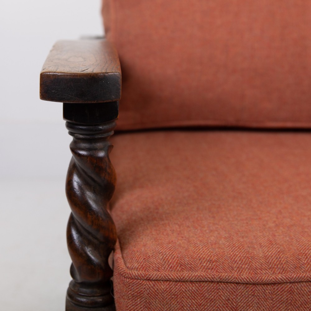 A pair of 1920s dark oak armchairs featuring barley twist supports, woven cane side panels, and terracotta upholstered cushions. View VIII