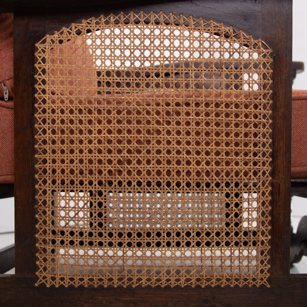 A pair of 1920s dark oak armchairs featuring barley twist supports, woven cane side panels, and terracotta upholstered cushions. View IX