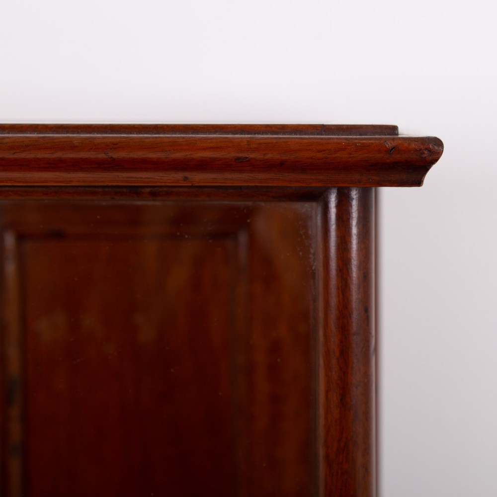 A vertical glazed tabletop display cabinet crafted from warm brown mahogany with glass side panels, turned columns, and a green felt-lined base. View IV