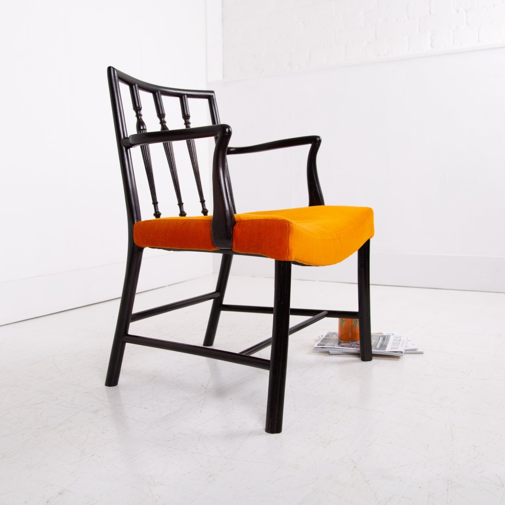 An ebonised wooden Cockpen armchair featuring a turned spindled backrest, curved armrests, and an orange velvet seat. View II