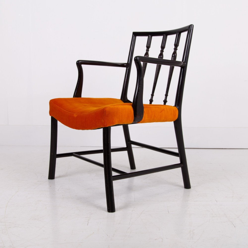 An ebonised wooden Cockpen armchair featuring a turned spindled backrest, curved armrests, and an orange velvet seat. View VI