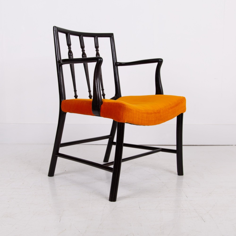 An ebonised wooden Cockpen armchair featuring a turned spindled backrest, curved armrests, and an orange velvet seat. View XI