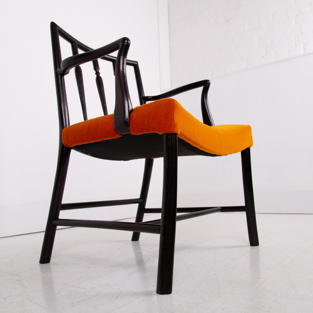 An ebonised wooden Cockpen armchair featuring a turned spindled backrest, curved armrests, and an orange velvet seat. View XIV