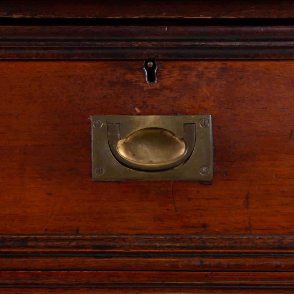 A late nineteenth-century dark mahogany drop-leaf table featuring a single top drawer with a brass pull, two lower open shelves, and fluted legs. View VII