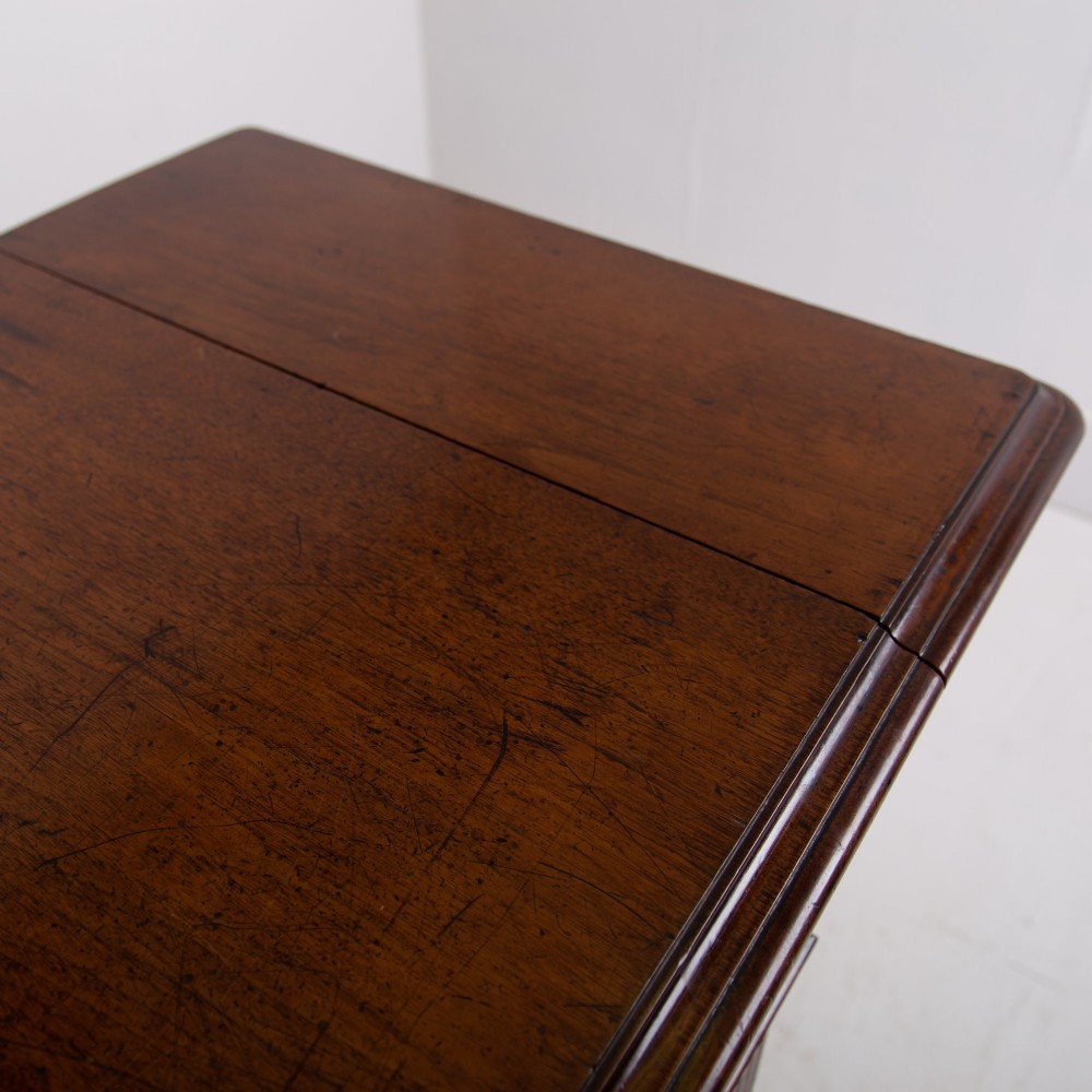 A late nineteenth-century dark mahogany drop-leaf table featuring a single top drawer with a brass pull, two lower open shelves, and fluted legs. View X
