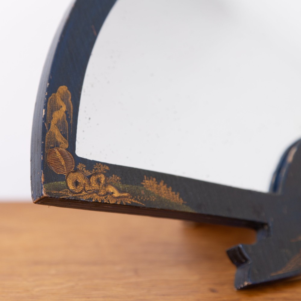 A small fan-shaped tabletop mirror with a black lacquered frame featuring hand-painted gold Chinoiserie detailing. View V