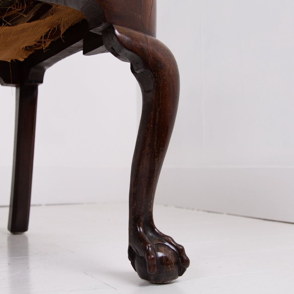 A George II revival double chair-back mahogany settee featuring carved vase splats, cabriole legs with claw and ball feet, and a green upholstered seat. View VI