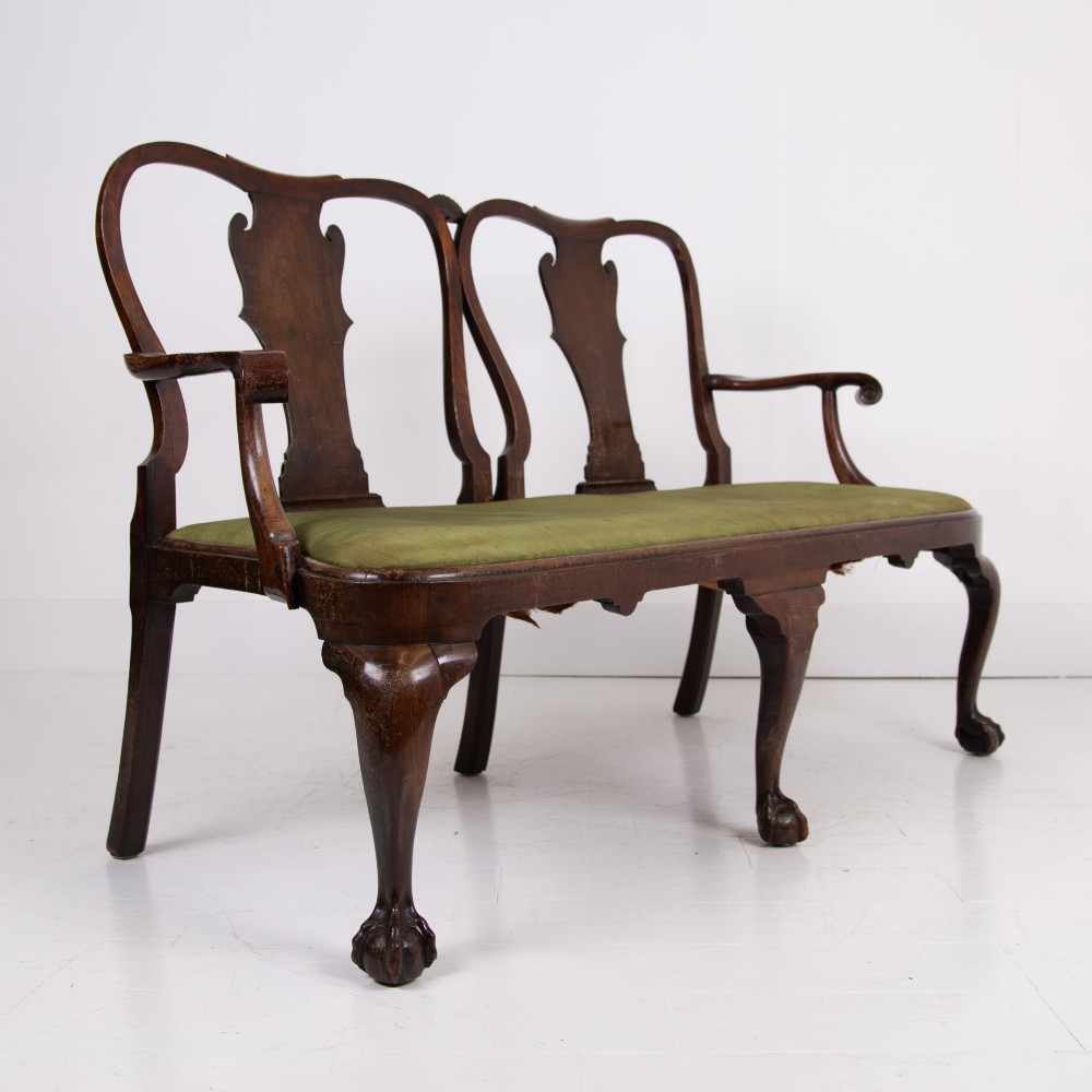 A George II revival double chair-back mahogany settee featuring carved vase splats, cabriole legs with claw and ball feet, and a green upholstered seat. View VIII