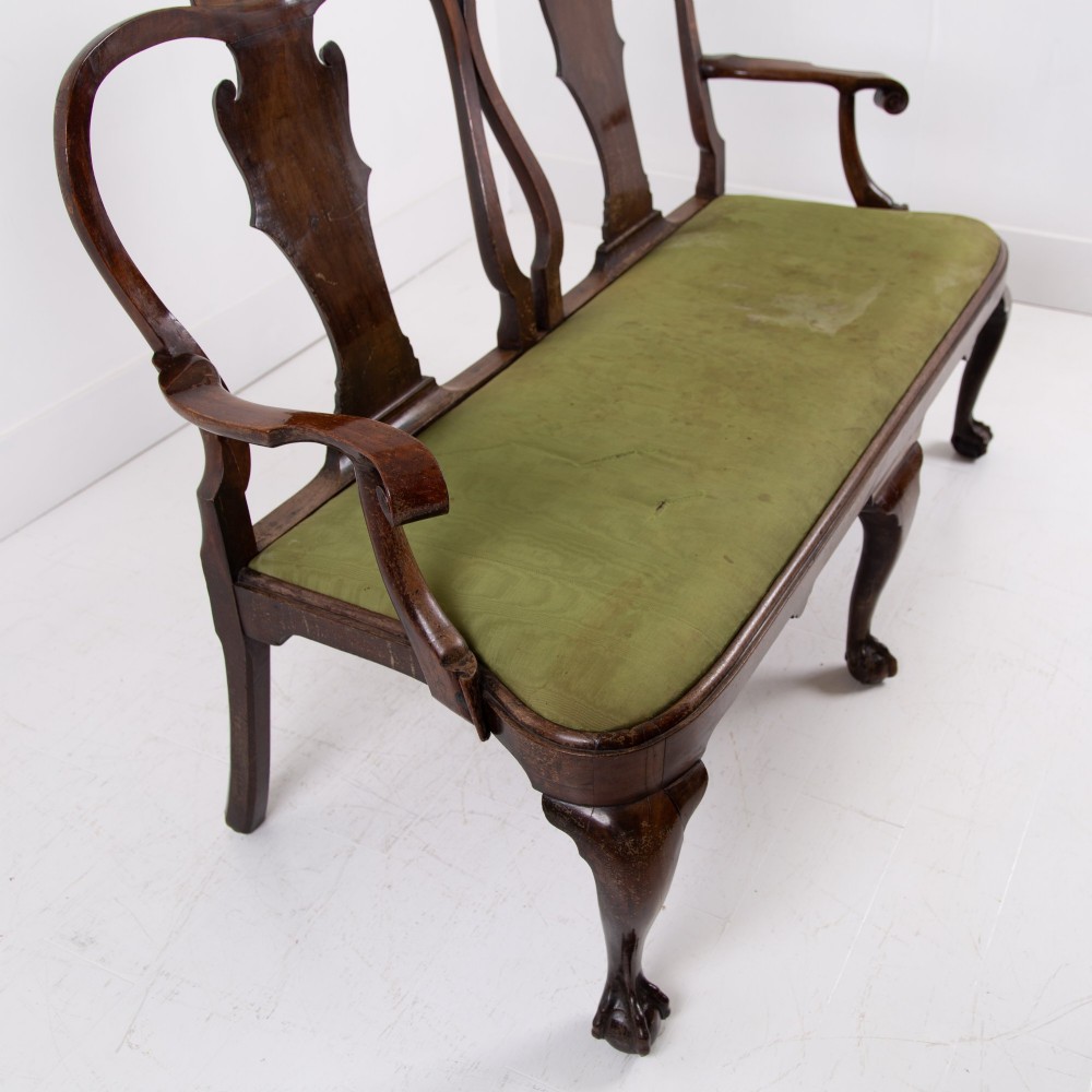 A George II revival double chair-back mahogany settee featuring carved vase splats, cabriole legs with claw and ball feet, and a green upholstered seat. View XII