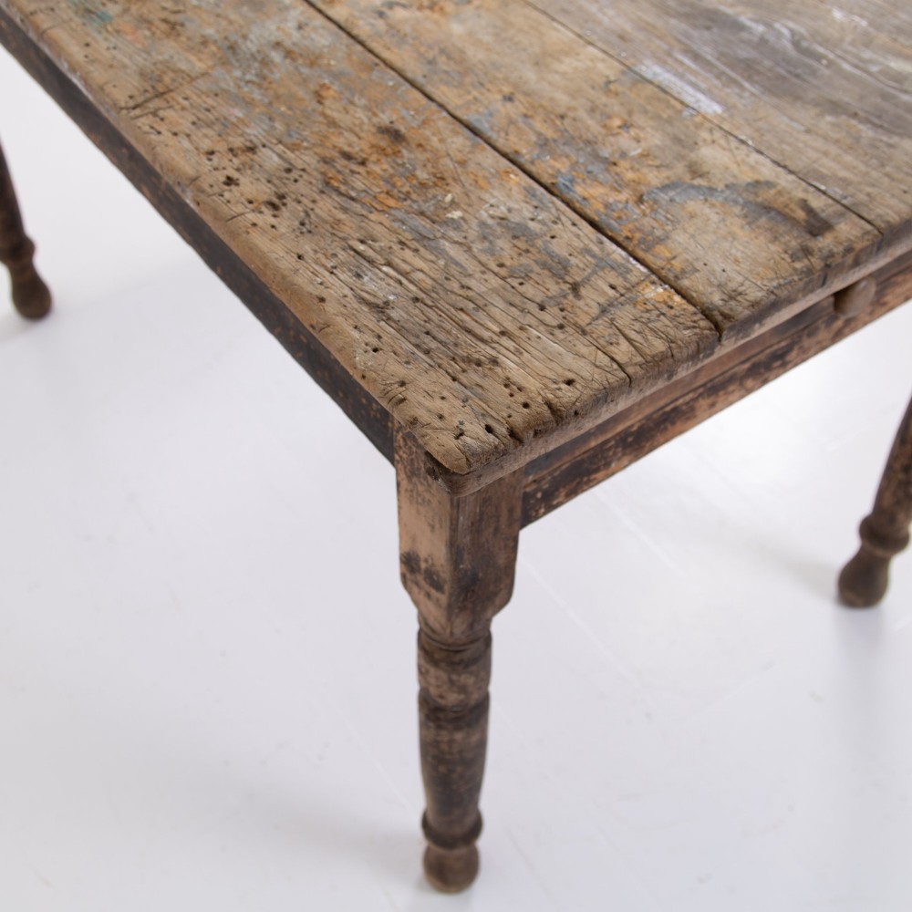 A late Victorian rustic wooden kitchen table featuring turned legs, a single drawer, and a distressed dark finish. View V