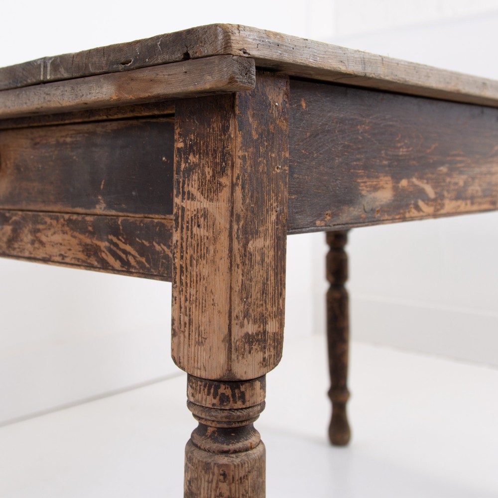 A late Victorian rustic wooden kitchen table featuring turned legs, a single drawer, and a distressed dark finish. View VI