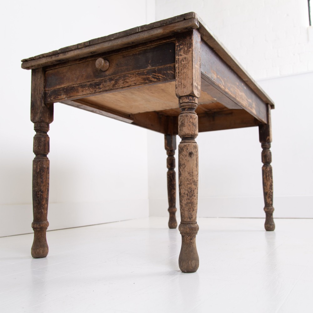 A late Victorian rustic wooden kitchen table featuring turned legs, a single drawer, and a distressed dark finish. View VIII