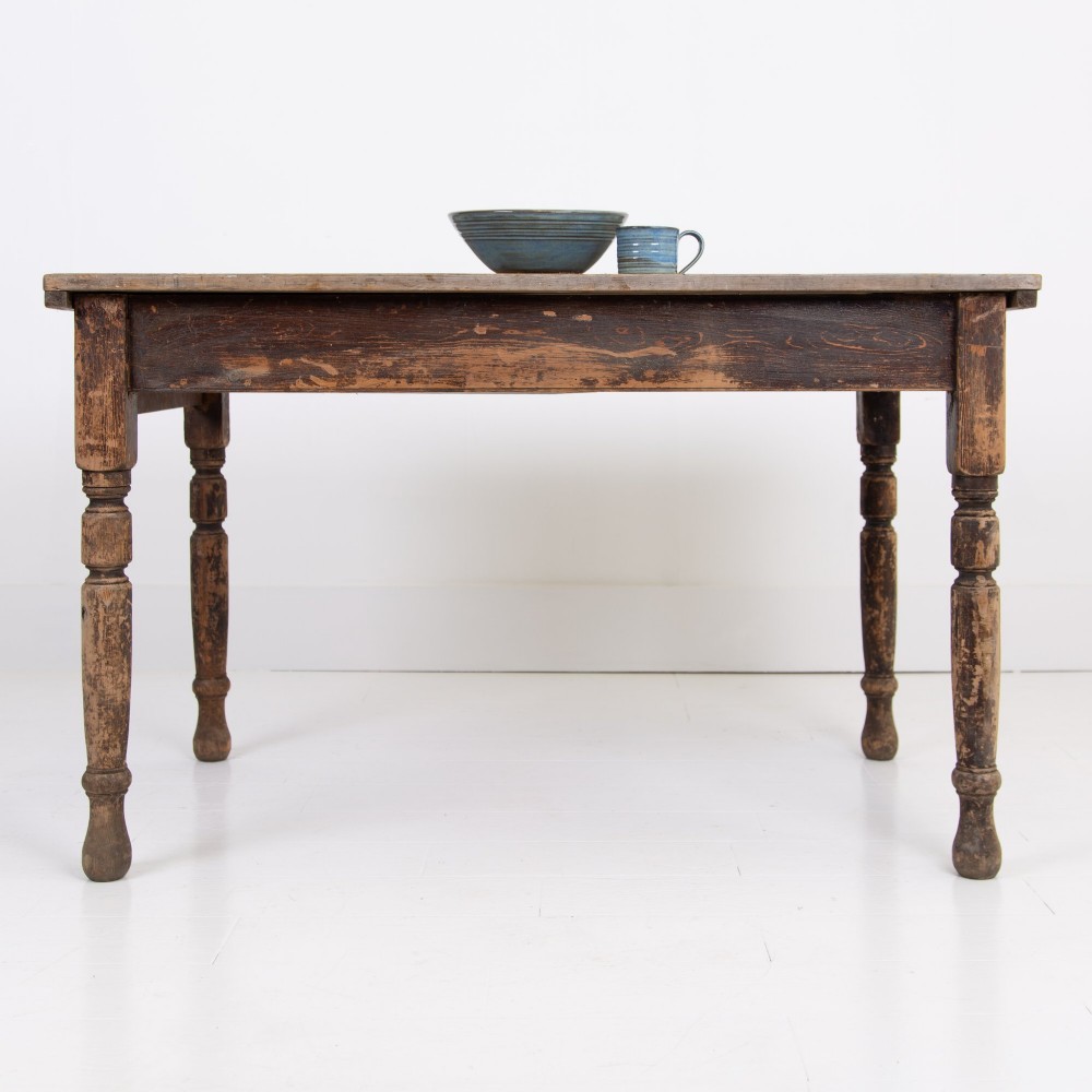 A late Victorian rustic wooden kitchen table featuring turned legs, a single drawer, and a distressed dark finish. View IX