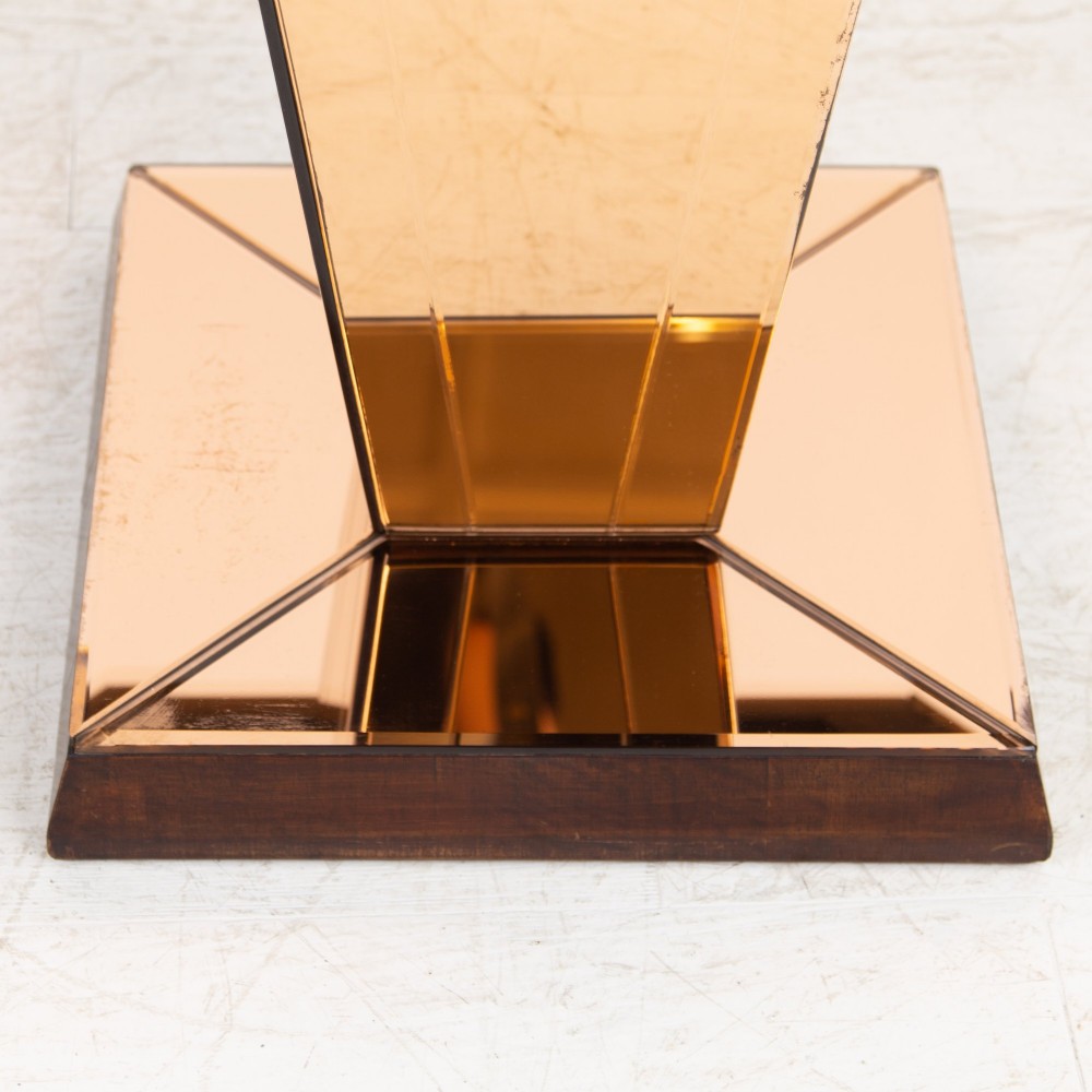 A pair of 1930s Art Deco side tables featuring peach-tinted mirrored tops, inverted pyramidal pedestal bases, and stepped square foundations. View VI