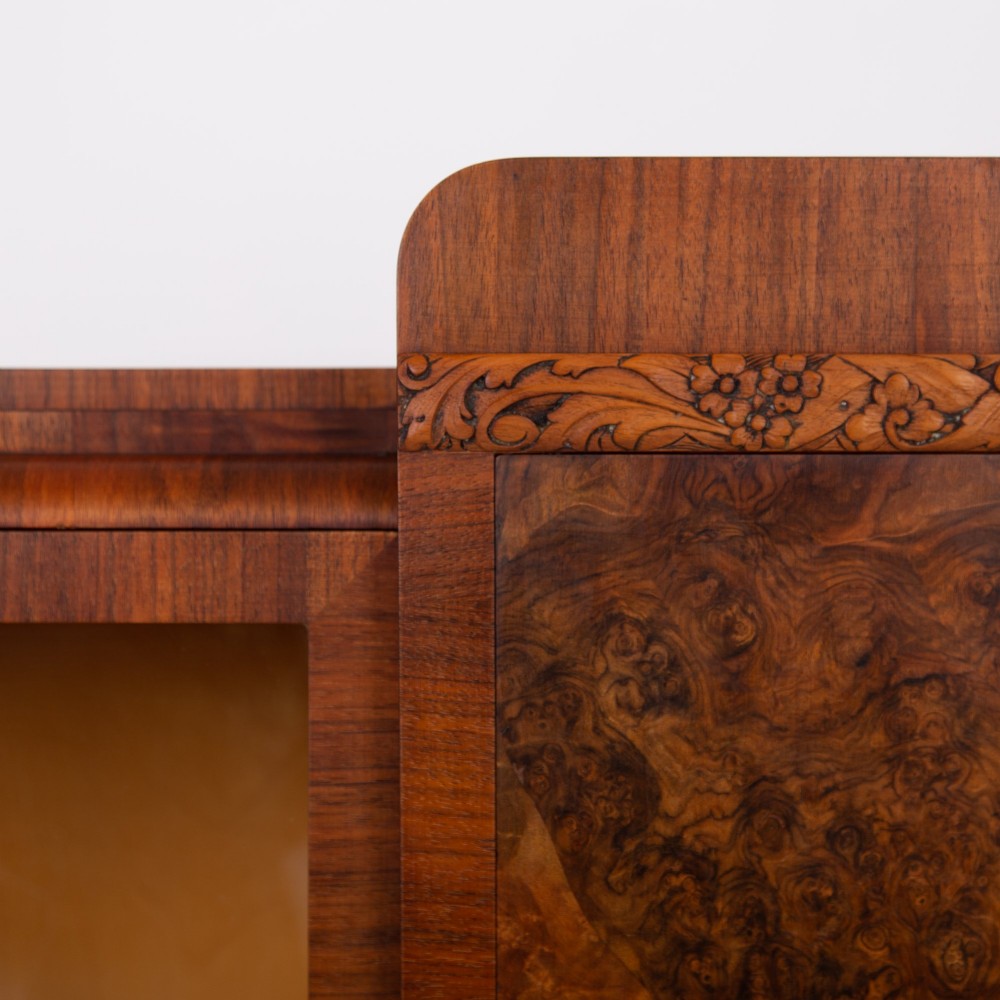 An Art Deco walnut display cabinet featuring a central burr walnut door flanked by two glazed doors with geometric diamond glazing bars. View VIII