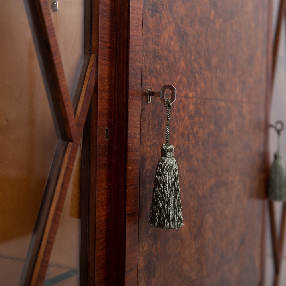 An Art Deco walnut display cabinet featuring a central burr walnut door flanked by two glazed doors with geometric diamond glazing bars. View XIII