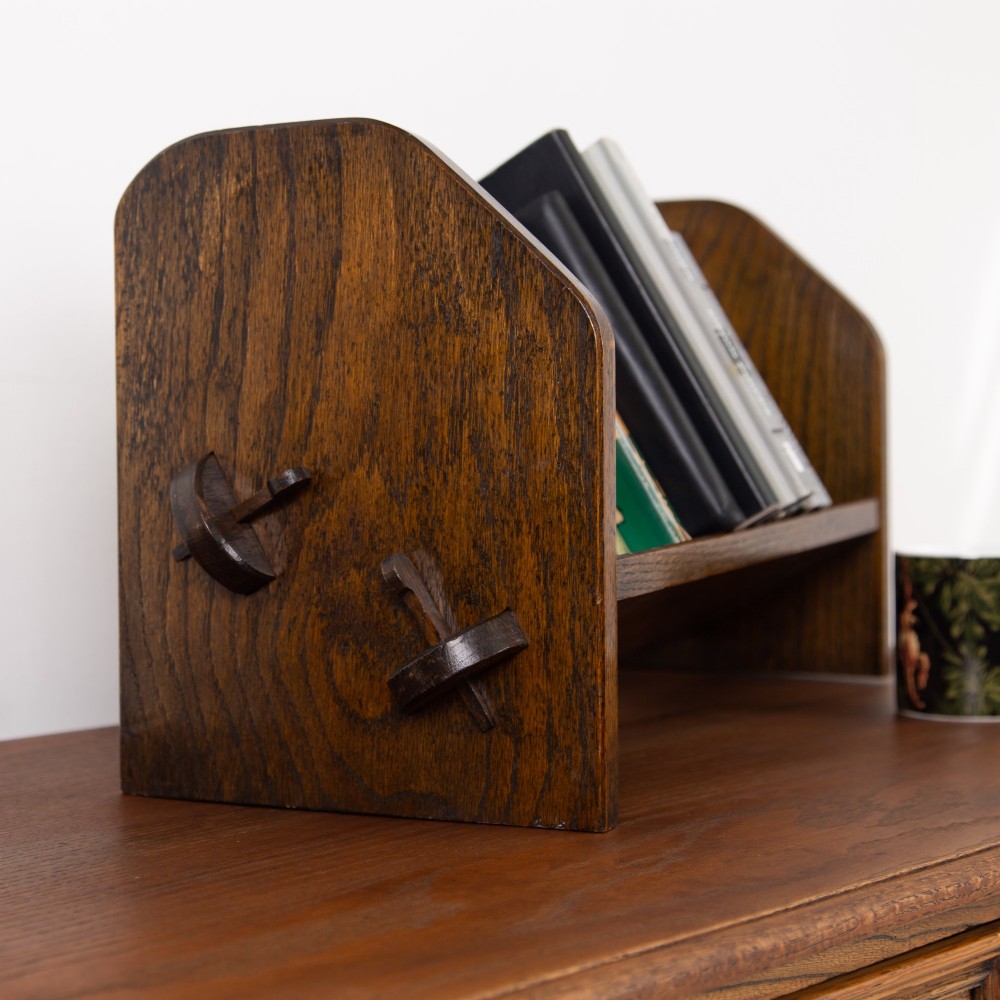 An English Arts and Crafts medium brown oak book trough featuring angled shelf panels and exposed wedge peg joinery. View III