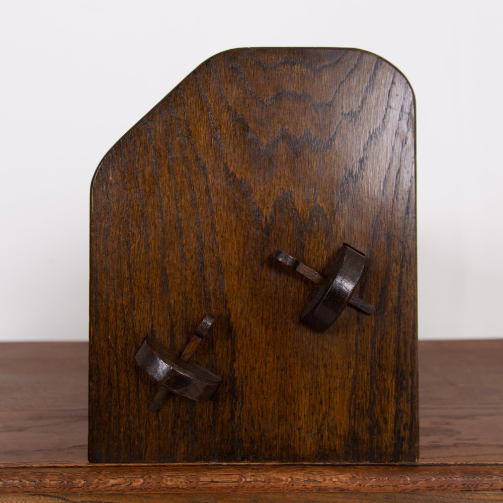 An English Arts and Crafts medium brown oak book trough featuring angled shelf panels and exposed wedge peg joinery. View VIII