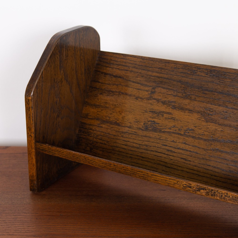 An English Arts and Crafts medium brown oak book trough featuring angled shelf panels and exposed wedge peg joinery. View IX