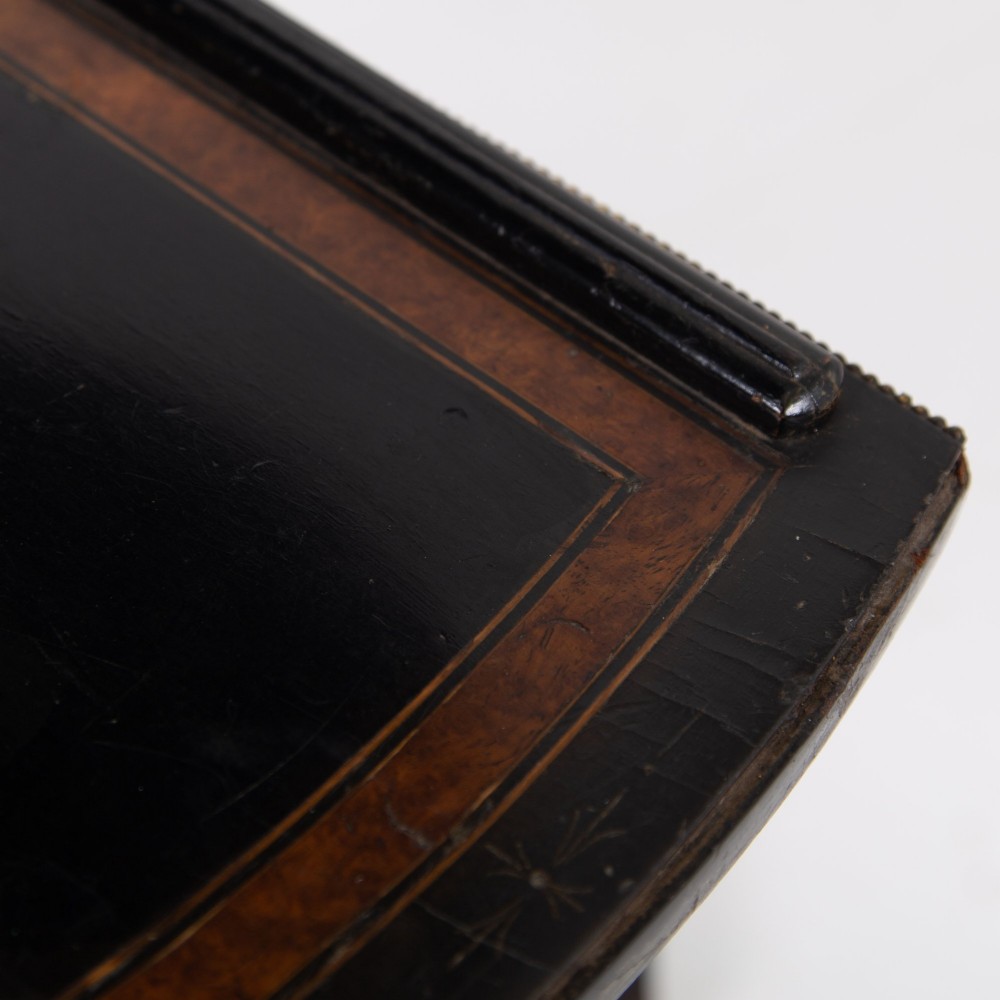 A Victorian ebonised side table featuring a circular top inlaid with amboyna wood, a central turned column, a lower cruciform tier, and a four-point flared base. View XI