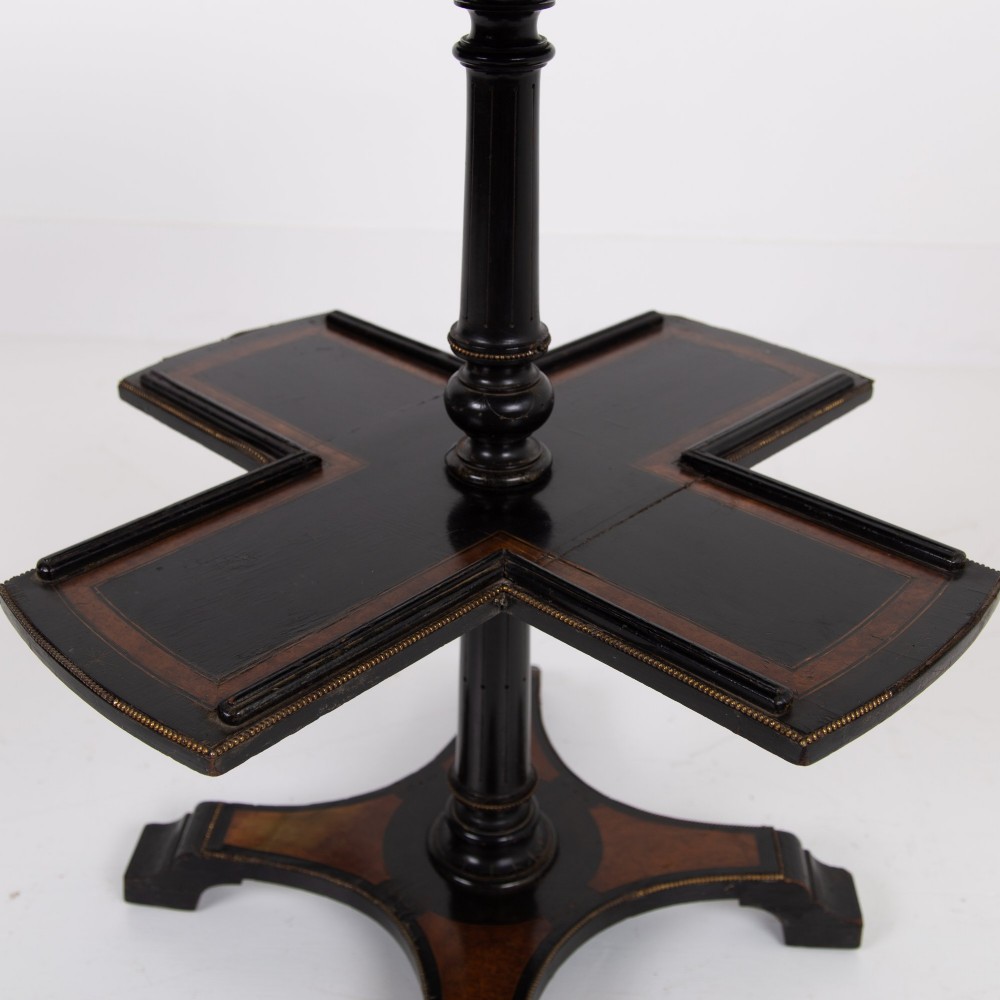 A Victorian ebonised side table featuring a circular top inlaid with amboyna wood, a central turned column, a lower cruciform tier, and a four-point flared base. View XIV