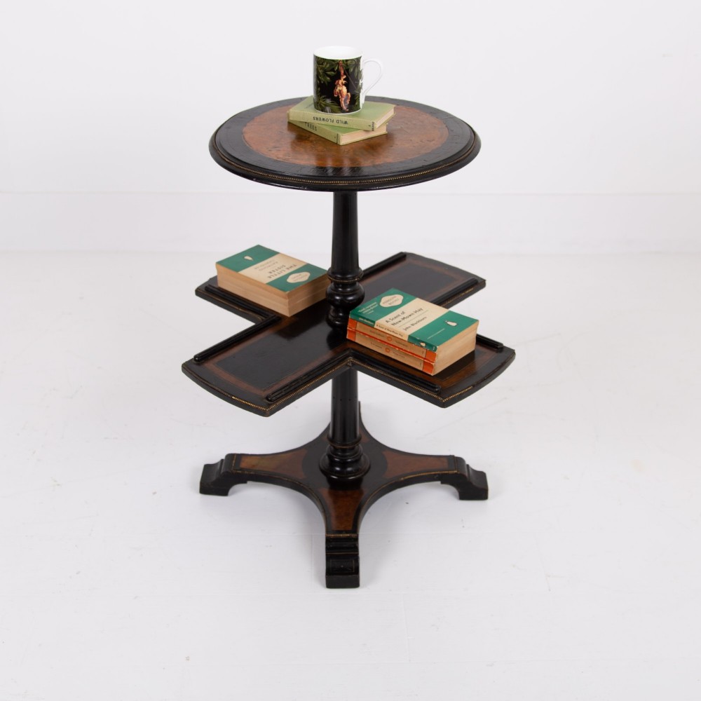 A Victorian ebonised side table featuring a circular top inlaid with amboyna wood, a central turned column, a lower cruciform tier, and a four-point flared base. View XV
