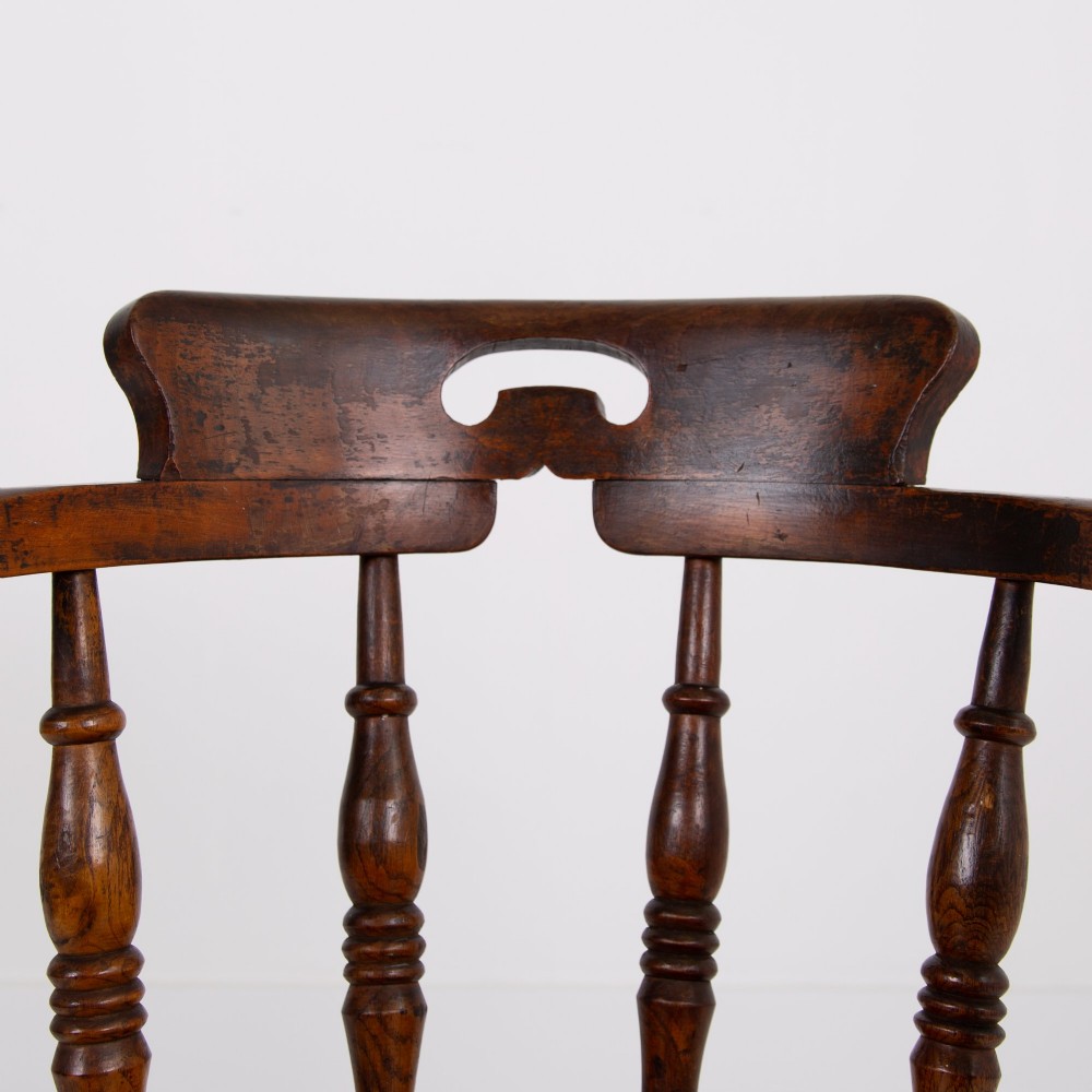 An antique 19th-century wooden smokers bow armchair with turned spindles, a curved horseshoe armrest, and a shaped seat. View XII