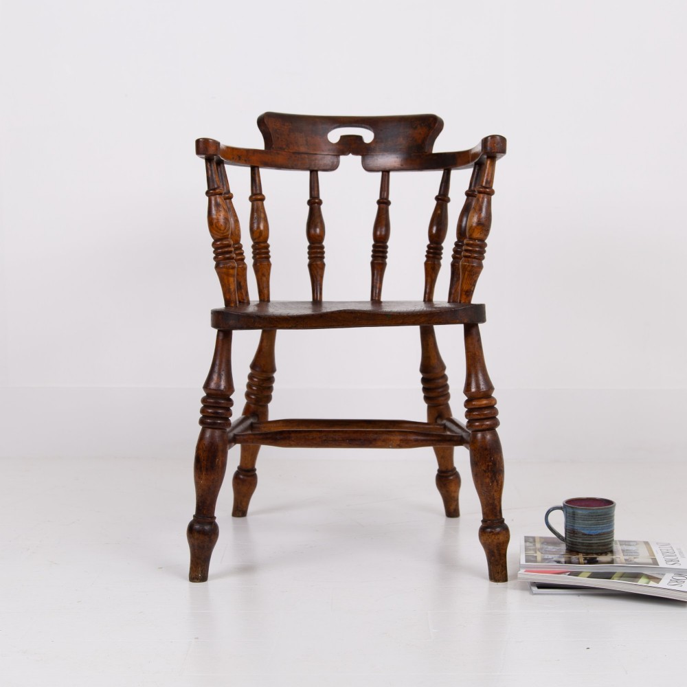 An antique 19th-century wooden smokers bow armchair with turned spindles, a curved horseshoe armrest, and a shaped seat. View XIV