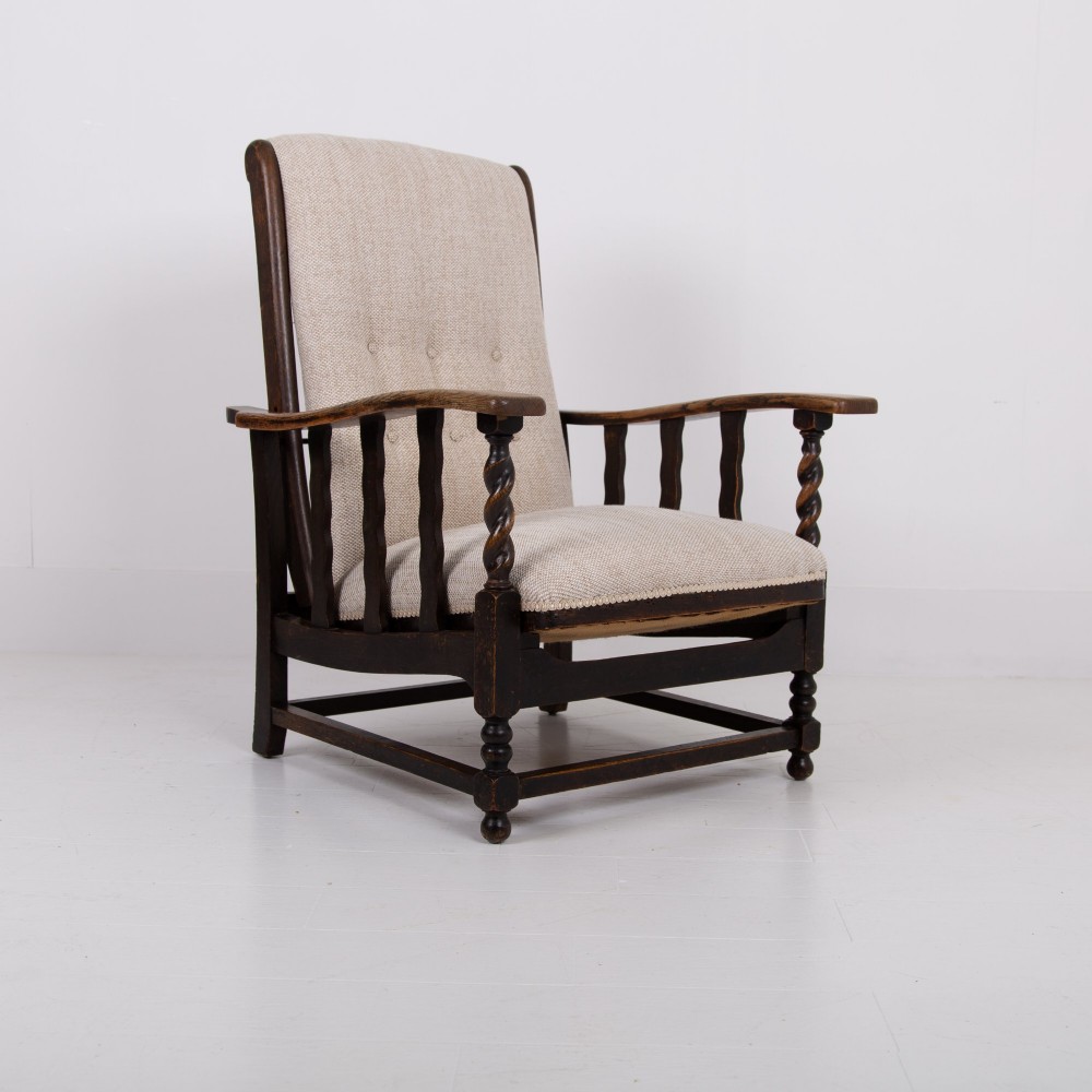 A pair of dark oak reclining armchairs with barley twist front supports, slatted sides, and beige textured upholstery. View XI