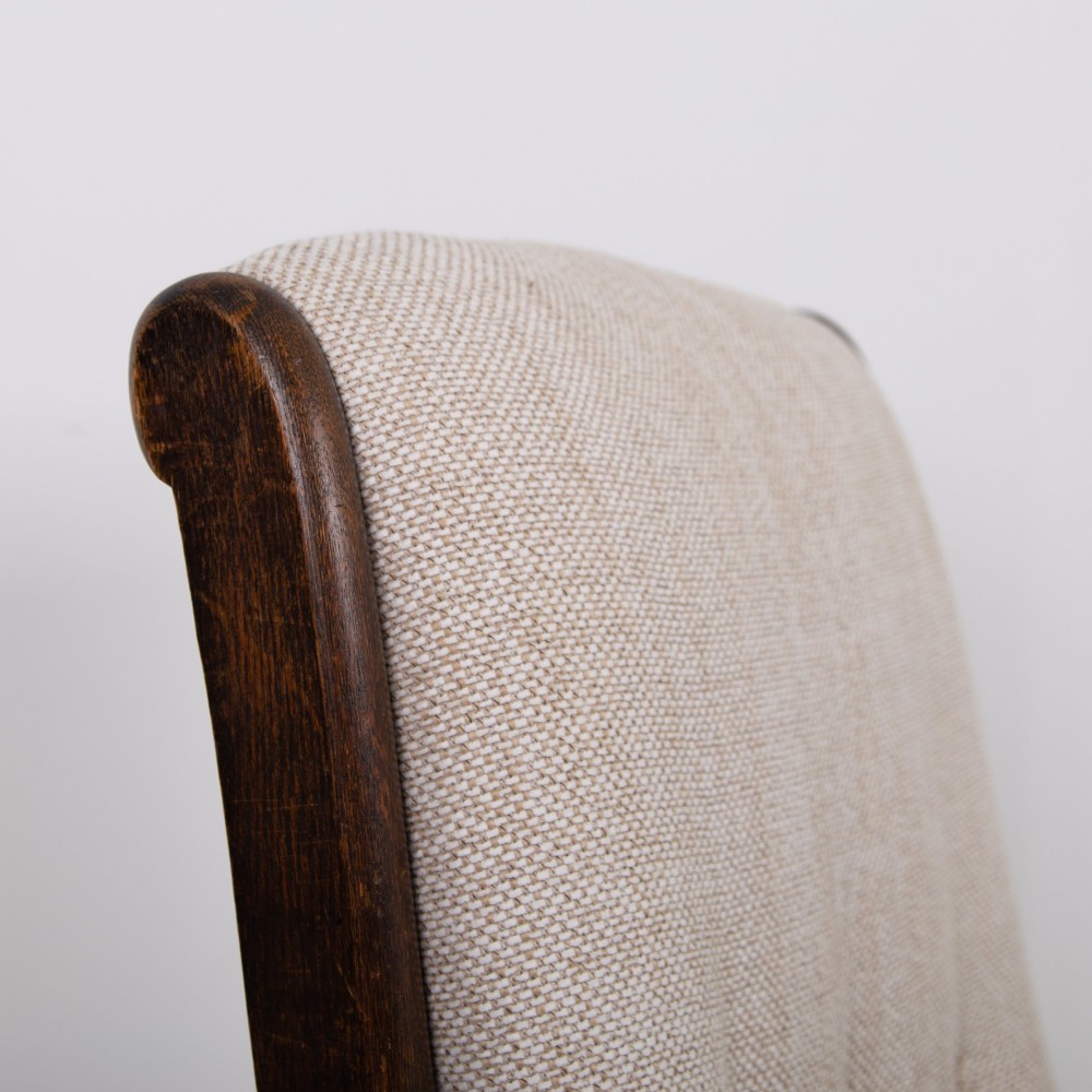 A pair of dark oak reclining armchairs with barley twist front supports, slatted sides, and beige textured upholstery. View XII