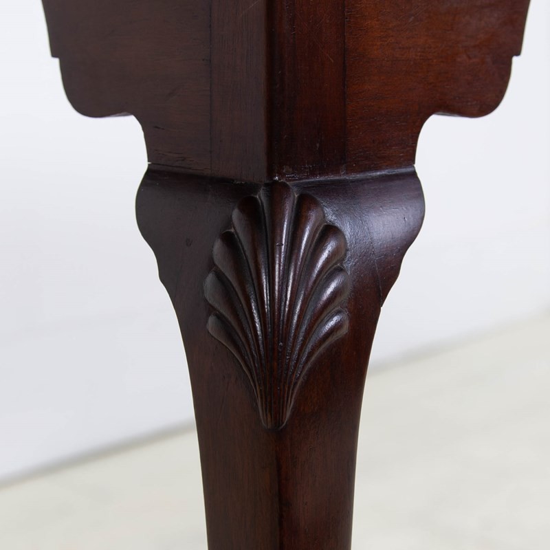 An antique dark mahogany side table featuring a scalloped piecrust top, arched aprons, slender cabriole legs with shell-carved knees, and a central circular lower tier. View IV