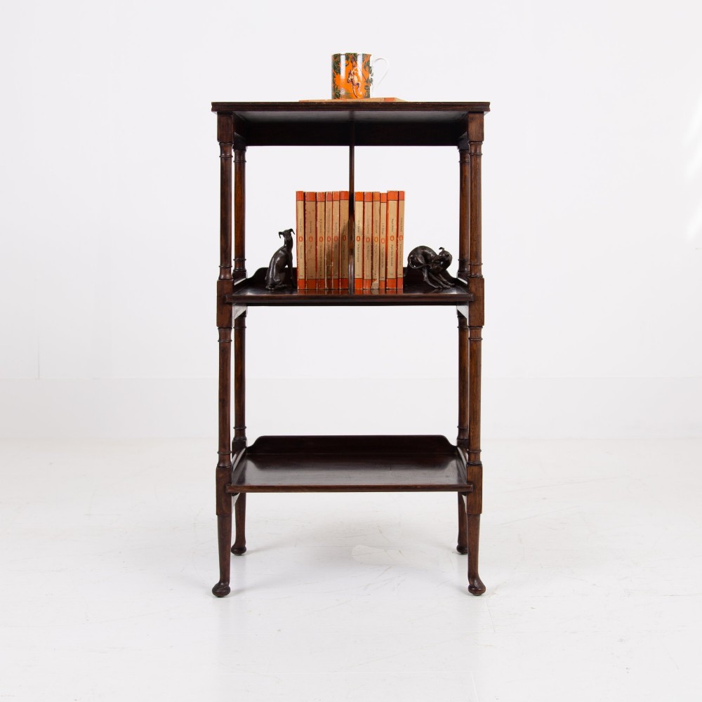 A dark brown mahogany Regency Revival whatnot with three open shelves, slender turned columns, and a vertical divider on the central tier. View III