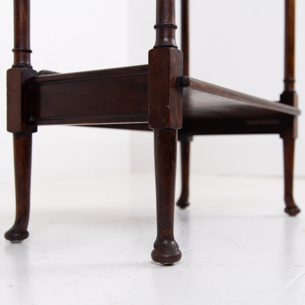 A dark brown mahogany Regency Revival whatnot with three open shelves, slender turned columns, and a vertical divider on the central tier. View IX