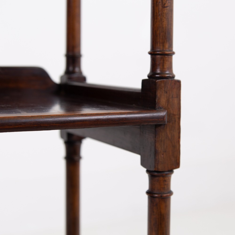 A dark brown mahogany Regency Revival whatnot with three open shelves, slender turned columns, and a vertical divider on the central tier. View XI