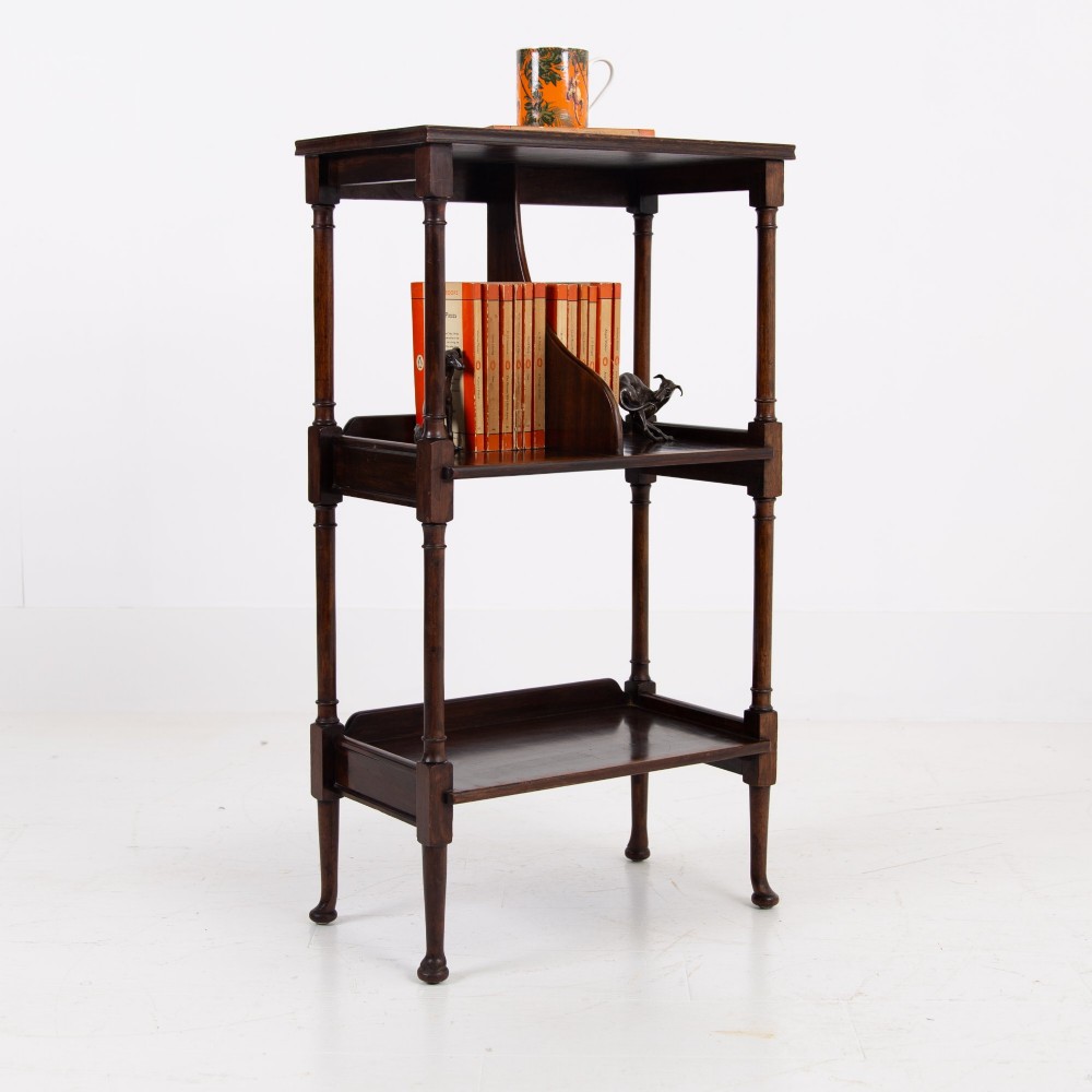 A dark brown mahogany Regency Revival whatnot with three open shelves, slender turned columns, and a vertical divider on the central tier. View XII