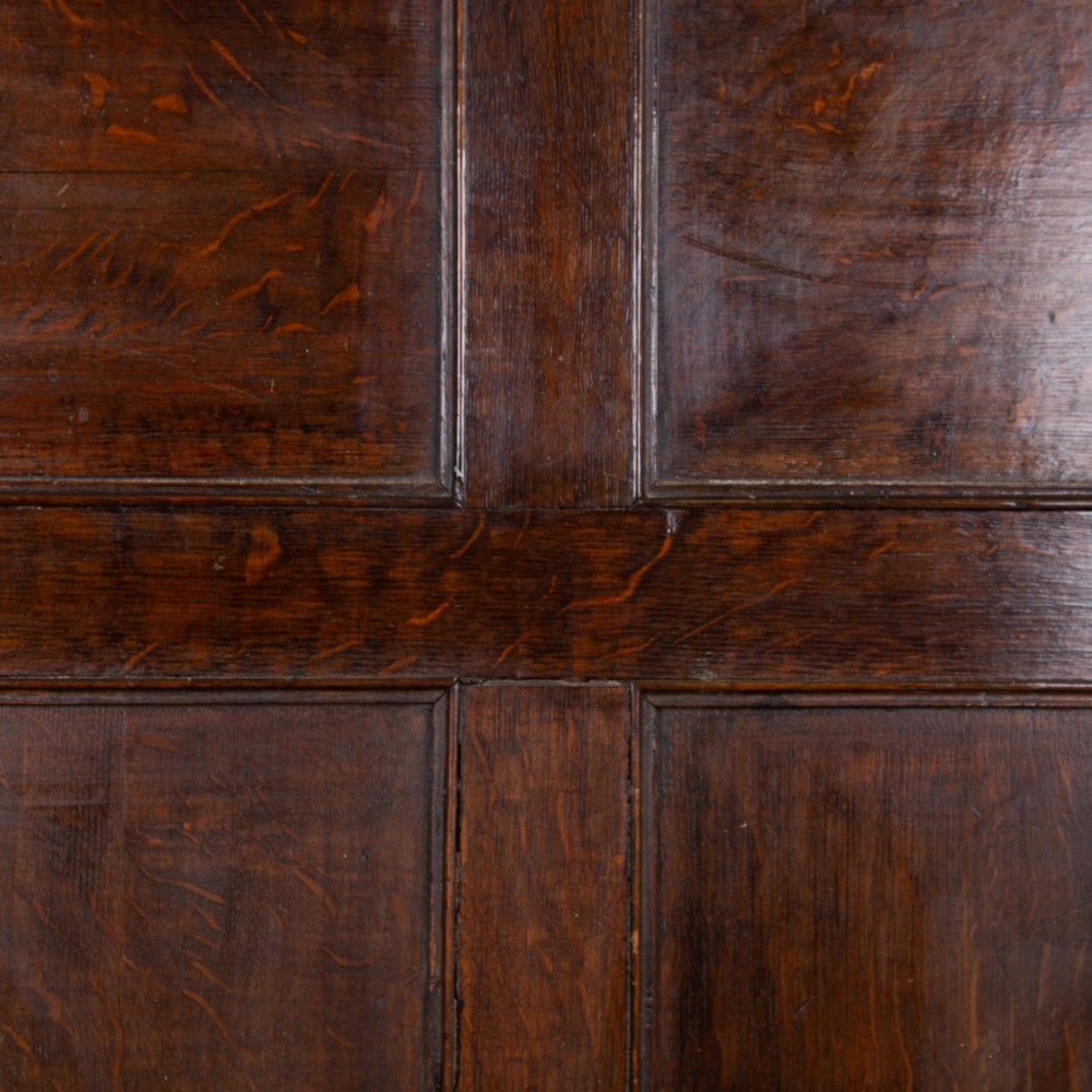 A 19th-century dark oak high-back box settle with panelled detailing, scrolled armrests, turned supports, and a hinged seat opening to a box storage base. View XIII