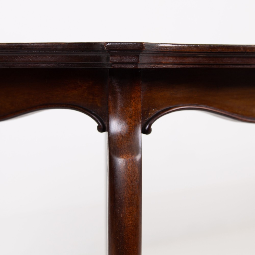An Edwardian mahogany occasional side table featuring a scalloped rim top, slender cabriole legs, and a matching lower undertier shelf. View III