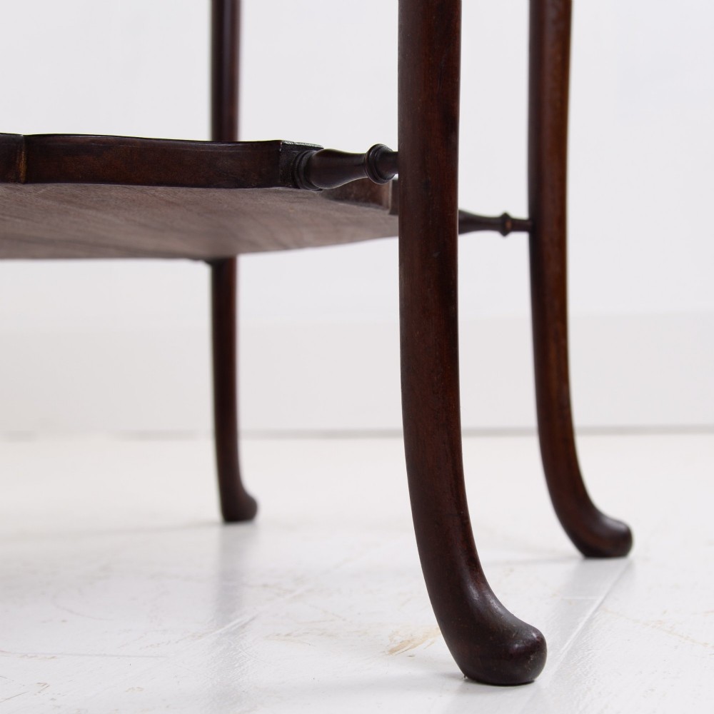 An Edwardian mahogany occasional side table featuring a scalloped rim top, slender cabriole legs, and a matching lower undertier shelf. View VII