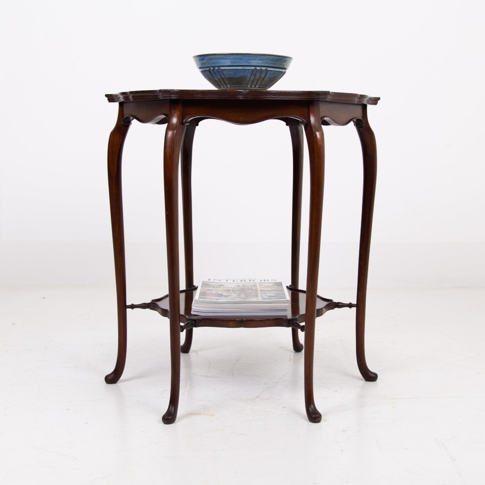 An Edwardian mahogany occasional side table featuring a scalloped rim top, slender cabriole legs, and a matching lower undertier shelf. View XIII