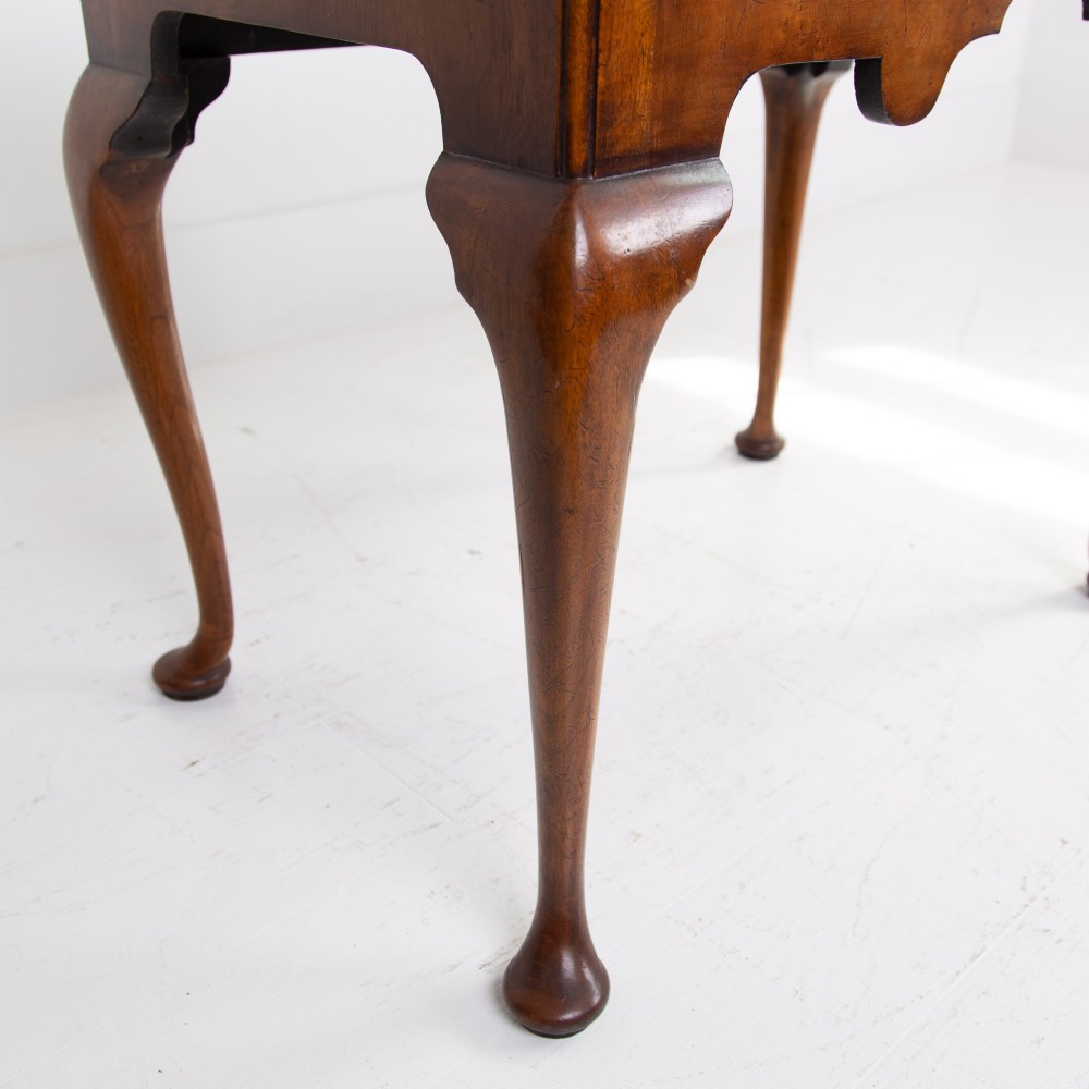 An antique warm brown walnut lowboy table featuring three drawers with brass handles, a shaped apron, and four cabriole legs ending in pad feet. View V