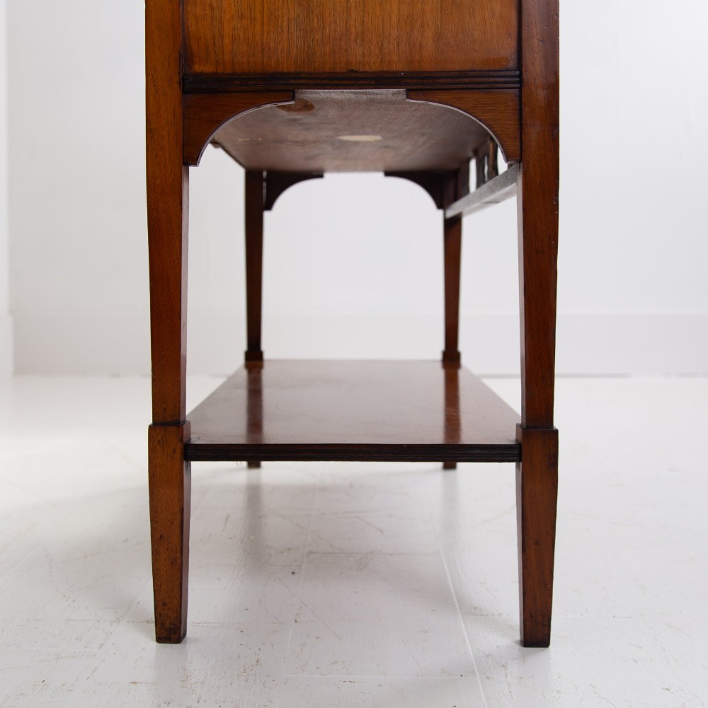 An Aesthetic Movement dark mahogany glazed cabinet with an intricate fretwork upper superstructure, mirrored back, twin glass doors, and a open lower shelf. View VII