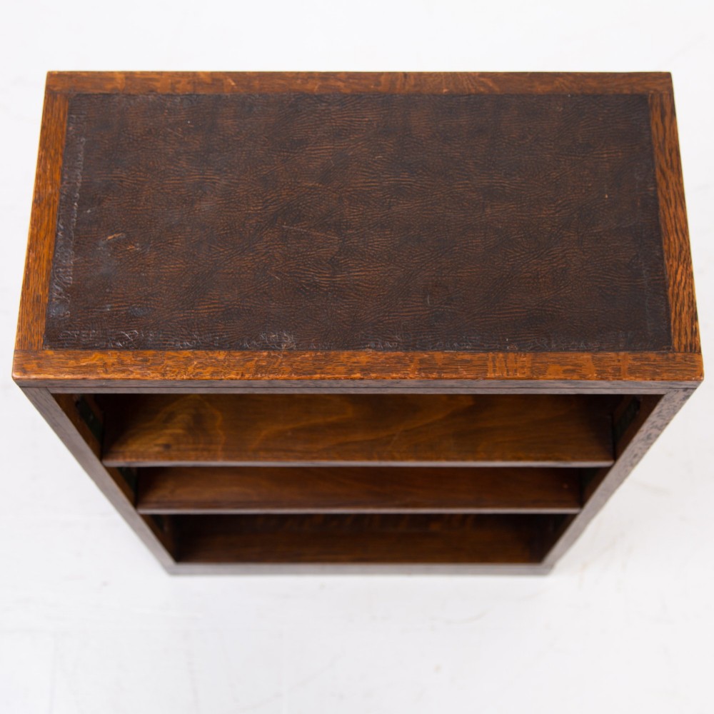 A 1930s dark oak open bookcase featuring two adjustable shelves, a leather-inset top surface, and a solid plinth base. View VI