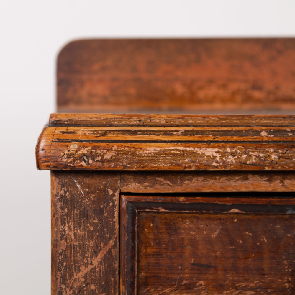 A 19th-century dark brown painted wooden kitchen dresser with seven drawers, a central cupboard, wooden knobs, and turned feet. View III
