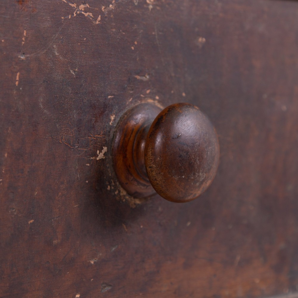 A 19th-century dark brown painted wooden kitchen dresser with seven drawers, a central cupboard, wooden knobs, and turned feet. View IV