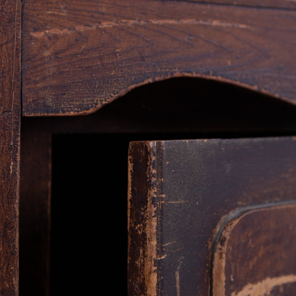 A 19th-century dark brown painted wooden kitchen dresser with seven drawers, a central cupboard, wooden knobs, and turned feet. View V