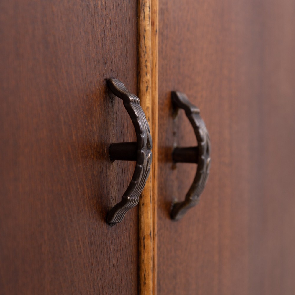 An Art Deco oak cabinet featuring two upper leaded glass doors with a geometric motif and a lower two-door wooden cupboard on stepped feet. View IX