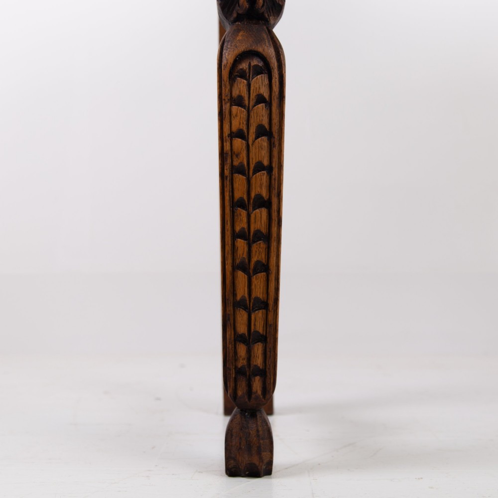 An ornate carved oak console table with a decorative mask crest upstand, an intricate interlace apron design, and carved turned legs. View VIII