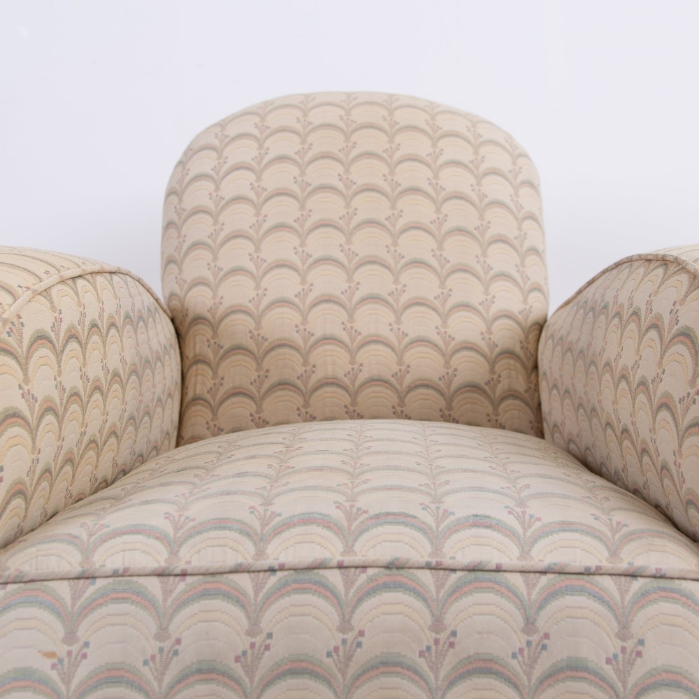 A pair of 1930s Art Deco upholstered armchairs featuring rounded arms, a scalloped fabric pattern, and small integrated casters. View IX